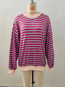 Detailed view of red and blue striped sweatshirt with beige ribbed collar and cuffs