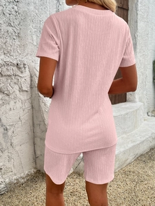 Rear view of pink waffle knit casual two-piece shorts set shown in outdoor setting