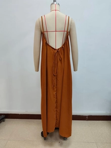 Detail view of the backless caramel maxi dress with thin straps and waist tie design