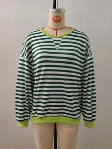 Detail of green and white striped crewneck sweatshirt with ribbed cuffs and contrast stitching