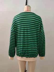 Detail of green and black striped long-sleeve top with contrast beige ribbed neckband