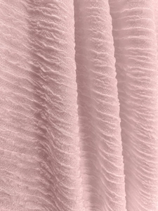 Macro shot of pink pleated fabric texture with vertical folds for soft hoodies
