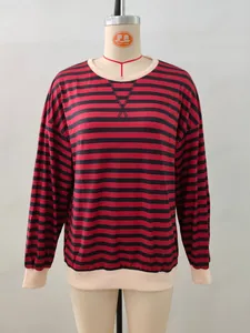 Detail of red and black striped shirt with beige ribbed neckline and triangle stitching