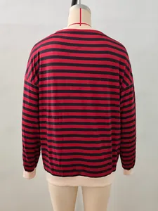 Detail of red and black striped knit top with beige ribbed neckline and cuffs