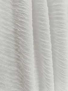 Macro shot of white pleated fabric texture with fine vertical accordion pleats detail