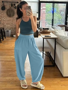 Detail of light blue jogger pants with elastic waist and cargo style side pockets