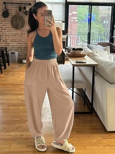 Mirror selfie of a woman wearing light brown high-waisted loose joggers with pockets