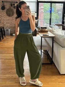 Detail of olive green cargo pants featuring large side pockets and elastic ankle cuffs