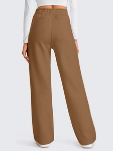Detail view of the elastic high waist and wide-leg cut on brown lounge pants