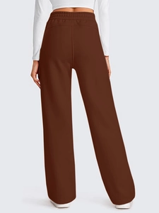 Detail view of the elastic waistband and high-waist design on brown wide-leg sweatpants