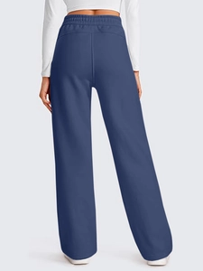 Rear view of high-waisted wide-leg navy track pants showing elastic waistband and back seams