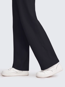 Detail shot of black wide-leg sweatpants showing side stitching and high-quality fabric