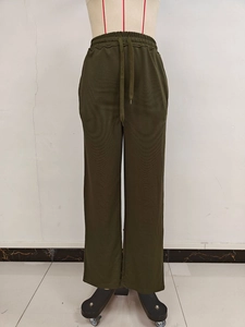 Detail view of army green wide leg pants showing elastic drawstring waistband and fabric