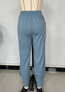 Detail of light blue joggers featuring elastic waistband and stitched ankle seam design