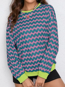 Detail of color-block wavy pattern sweatshirt with bright neon green ribbed collar and cuffs