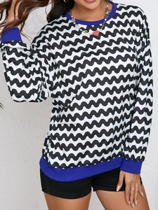 Detail of wave pattern sweatshirt featuring blue ribbed crewneck and cuffs for women