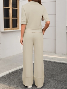 Rear view of beige two-piece leisure set featuring short-sleeved top and wide-leg trousers