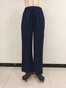 Detailed view of elastic drawstring waistband on navy blue wide-leg casual pants