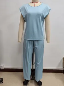 Detail of light blue sleeveless top and pants set in soft knit fabric on a mannequin