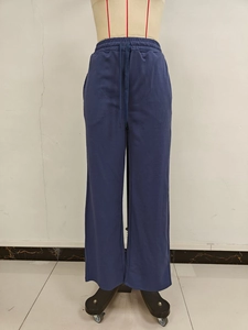 Detail of high waist elastic waistband and matching drawstring on navy wide-leg sweatpants
