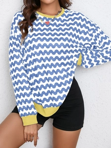 Detail of wavy blue and white stripe sweatshirt with yellow contrast rib-knit cuffs