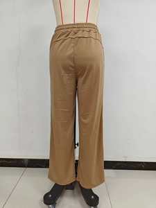 Detail view of khaki high-waisted wide-leg sweatpants featuring elastic drawstring waistband