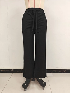 Detailed front view of high-waist black wide-leg trousers with adjustable drawstring waist