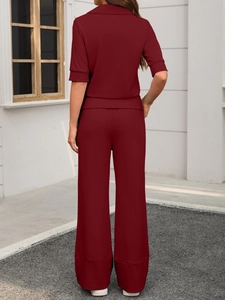 Rear view of burgundy lounge set featuring short sleeve shirt and wide leg trousers