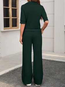 Back view of dark green two-piece set featuring short-sleeve shirt and wide-leg trousers