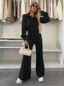 Chic black two-piece lounge set with polo neck top and elastic wide-leg trousers detail