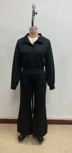 Detail view of black long sleeve polo top with cinched waist and wide leg pants set