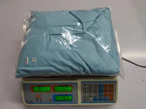 Sky blue long sleeve leisure set XXL being weighed on scale in packaging