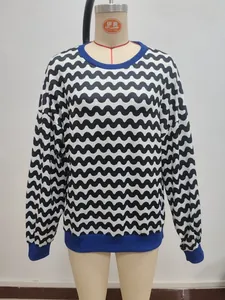 Detail of wave pattern sweatshirt with navy blue ribbed cuffs and round neckline