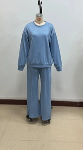 Detail of light blue knit loungewear set featuring ribbed cuffs and stitched front creases