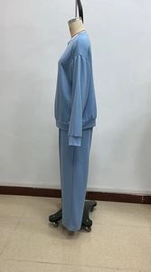 Detail of light blue lounge set featuring dropped shoulder top and ruched trousers