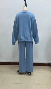 Rear view of a blue two-piece lounge set with long-sleeve top and wide-leg pants on mannequin