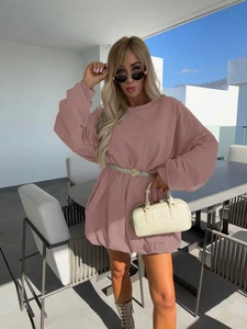 Pink long sleeve sweatshirt dress with crew neck and dropped shoulders in outdoor setting
