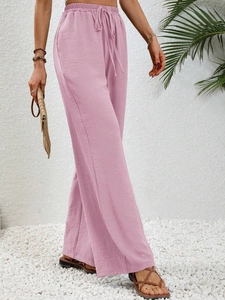 Detail of high waisted wide leg trousers in dusty pink with elastic drawstring waist