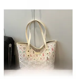Detail of floral tote bag featuring heart, teddy bear, and rabbit patterns on jacquard fabric