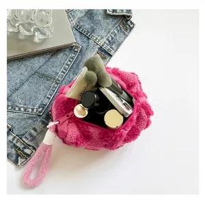 Macro view of plush rose pink makeup bag showing spacious interior and large capacity