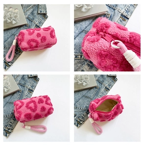Detail view of pink plush handbag with heart pattern and soft fleece texture