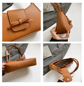 Détails du cuir marron à motif litchi, du décor de nœud et de la fermeture magnétique