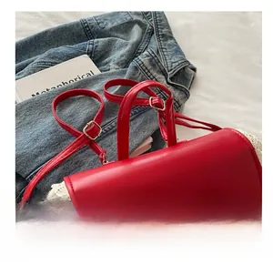 Detail of red backpack featuring cream lace edges and a delicate 3D bow design