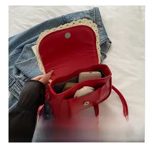 Detail view of the red PU leather backpack open to show interior storage capacity