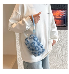 Detail of blue plush handbag featuring leopard texture and soft faux fur handle
