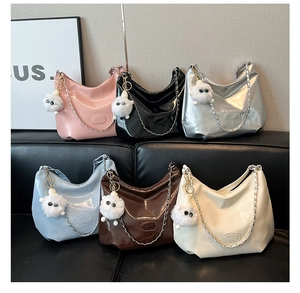 Chic patent leather hobo bags with metallic chains and plush charms in six vibrant colors