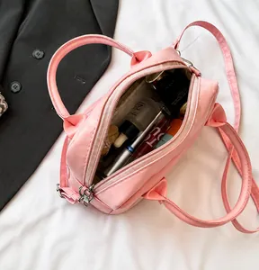 Macro shot showing internal capacity of the pink Boston bag with cosmetics items