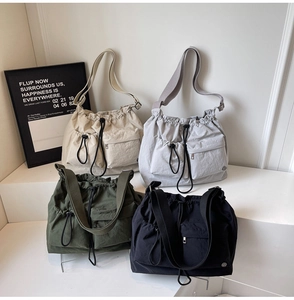 Collection of nylon drawstring bucket bags in beige, grey, olive and black colors