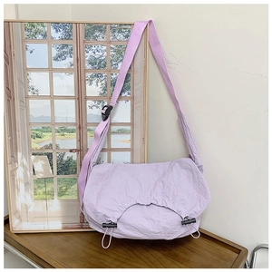 Dettaglio borsa a tracolla in nylon lavanda con ampia tracolla e dettagli decorativi a coulisse