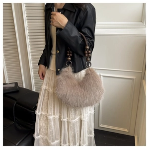 Detail of plush faux fur handbag featuring a unique dark brown wooden beaded handle